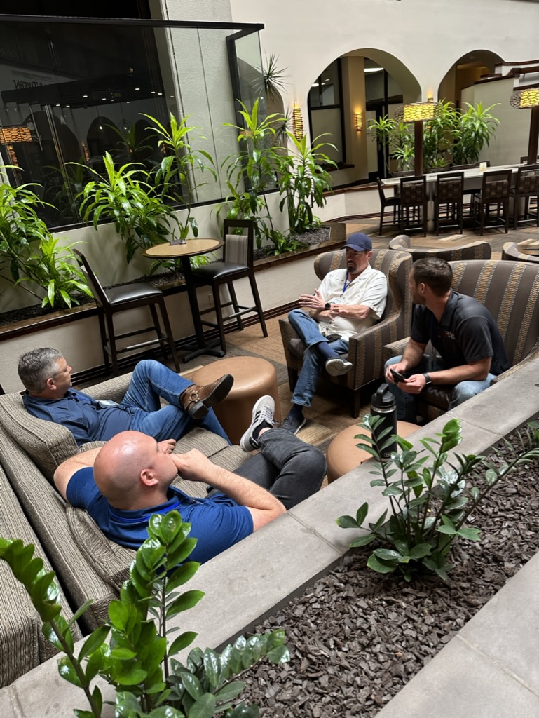 Real estate agents at a Black Sheep Broker convention discussing deals